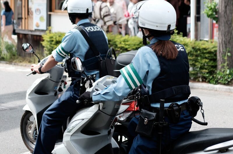 two police officers riding on the back of a motorcycle